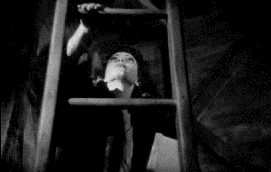 A low angle shot of a woman climbing a ladder